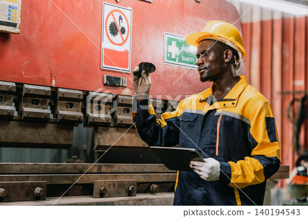Professional African black engineer male technician expert worker control operate machine in plant Professional African black engineer male technician expert worker control operate machine in plant 140194543