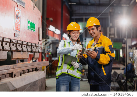 Professional worker man working in metal part workshop, Quality control staff looking product part. 140194563