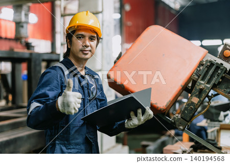 Portrait professional Asian engineer male worker working metal factory looking camera in safety Portrait professional Asian engineer male worker working metal factory looking camera in safety 140194568