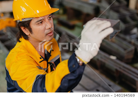 Professional worker man working in metal part workshop, Quality control staff looking product part. Professional worker man working in metal part workshop, Quality control staff looking product part. 140194569