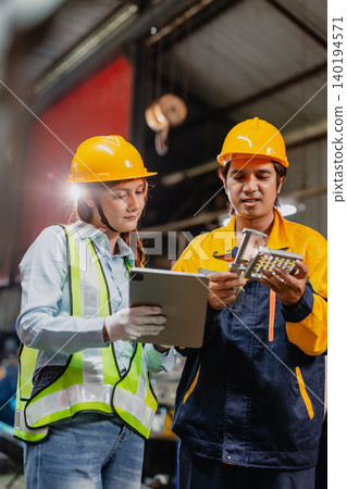 Professional worker man working in metal part workshop, Quality control staff looking product part. Professional worker man working in metal part workshop, Quality control staff looking product part. 140194571