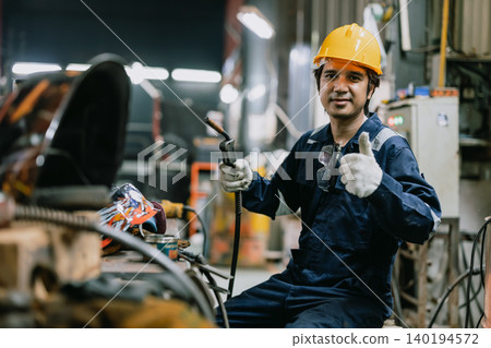 Portrait professional Asian male welder worker working metal factory looking camera in safety Portrait professional Asian male welder worker working metal factory looking camera in safety 140194572