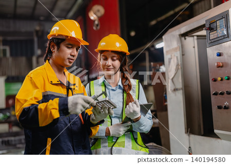 Professional engineer man and woman team working together checking inspecting production quality Professional engineer man and woman team working together checking inspecting production quality 140194580