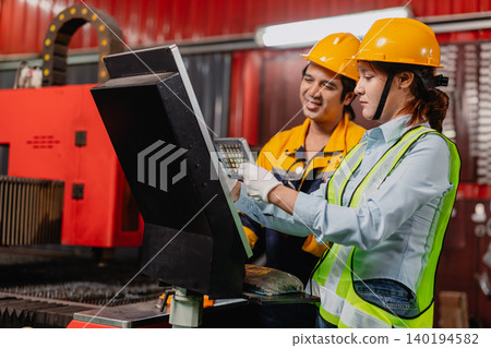 Engineer teamwork, Workers man and woman team working together in metal workshop plant factory. 140194582