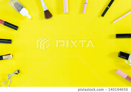 Bright yellow backdrop frames colorful cosmetics. Brushes, lipsticks, and tubes rest neatly arranged. Top and bottom borders hold beauty tools in order. Minimalist style draws attention to each item Bright yellow backdrop frames colorful cosmetics. Brushes, lipsticks, and tubes rest neatly arranged. Top and bottom borders hold beauty tools in order. Minimalist style draws attention to each item 140194650