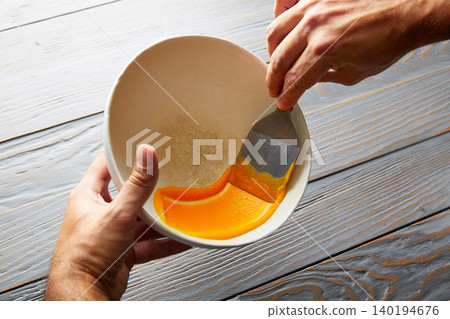 creamy carrot cream painted on white bowl 140194676