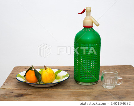 fruits tangerine and pear in vintage dish soda bottle fruits tangerine and pear in vintage dish soda bottle 140194682