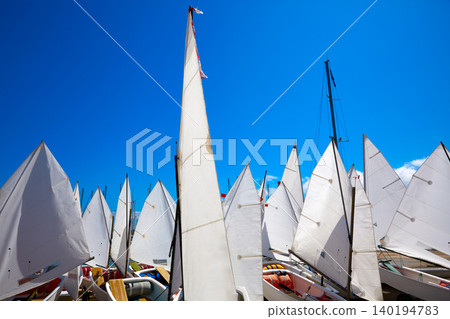 Sailboats school with sail textures in blue sky Sailboats school with sail textures in blue sky 140194783