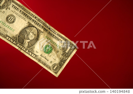 One dollar note over red background One dollar note over red background 140194848
