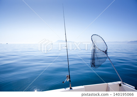 boat fishing rod and landing net in sea boat fishing rod and landing net in sea 140195066
