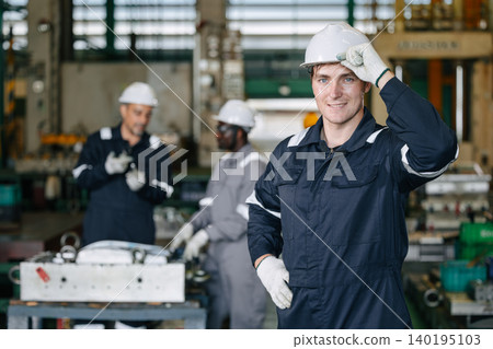 Engineer male worker success confident wearing hardhat for safety in industry factory looking camera Engineer male worker success confident wearing hardhat for safety in industry factory looking camera 140195103