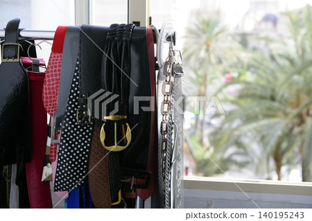 Rack of clothes with fashion accesories, belts Rack of clothes with fashion accesories, belts 140195243