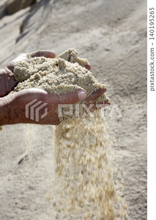 gravel sand in man hands in quarry showing camera 140195265