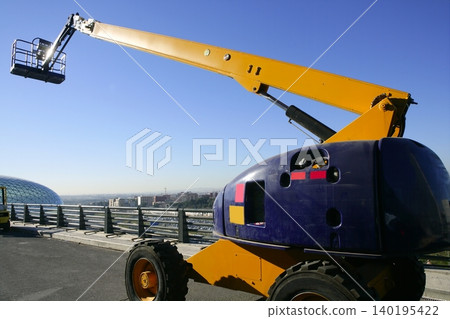 Car little hydraulic crane in blue and yellow colors Car little hydraulic crane in blue and yellow colors 140195422