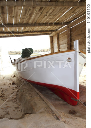Formentera boat stranded on wooden rails Formentera boat stranded on wooden rails 140195500