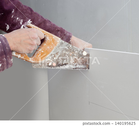 cutting plasterboard plaster hand dirty saw cutting plasterboard plaster hand dirty saw 140195625