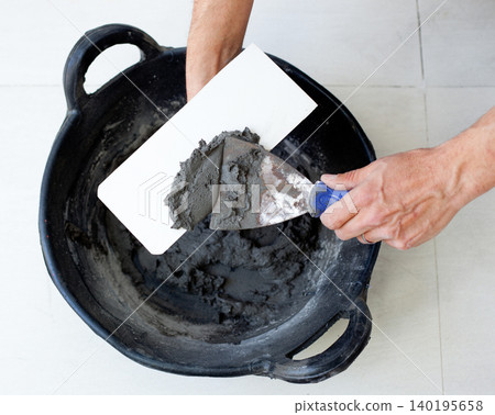 contruction mason worker hands with cement mortar contruction mason worker hands with cement mortar 140195658