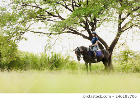 Horsewoman riding sport animal, Horseback rider. Girl teen ride horse happy fun in stable horse farm 140195706