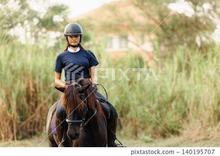 Horsewoman riding sport animal, Horseback rider. Girl teen ride horse happy fun in stable horse farm Horsewoman riding sport animal, Horseback rider. Girl teen ride horse happy fun in stable horse farm 140195707