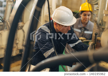 Engineer worker man working. Technician Engine Mechanic work maintenance machine in industry factory Engineer worker man working. Technician Engine Mechanic work maintenance machine in industry factory 140195962