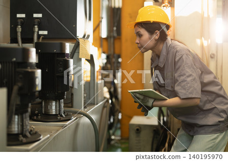 Women worker, Engineer woman hard working in heavy industry service machine in plant factory Women worker, Engineer woman hard working in heavy industry service machine in plant factory 140195970