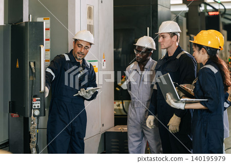 Professional senior engineer man training young engineer team to control operate machine in factory Professional senior engineer man training young engineer team to control operate machine in factory 140195979