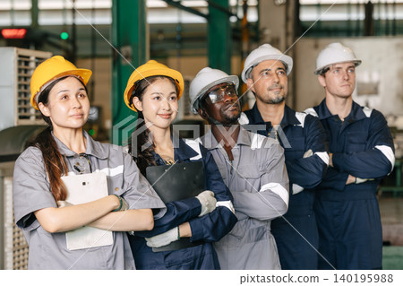 Group of professional success workers in safety uniforms stand together in heavy industry factory. 140195988