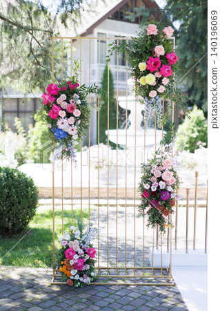 Wedding arch decorated with colorful flowers standing outdoor Wedding arch decorated with colorful flowers standing outdoor 140196069