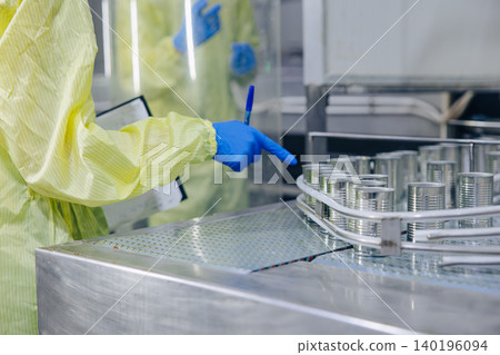 Food cannery industry hygiene worker check tin can for food product container, Canned food factory Food cannery industry hygiene worker check tin can for food product container, Canned food factory 140196094