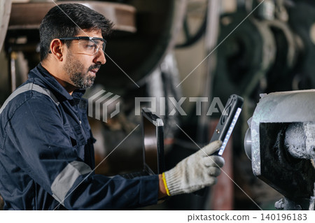 Mechanic Worker Hispanic Latin Indian male work service maintenance old Machine in metal plant Mechanic Worker Hispanic Latin Indian male work service maintenance old Machine in metal plant 140196183