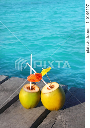 coconut coktails in caribbean on wood pier coconut coktails in caribbean on wood pier 140196297