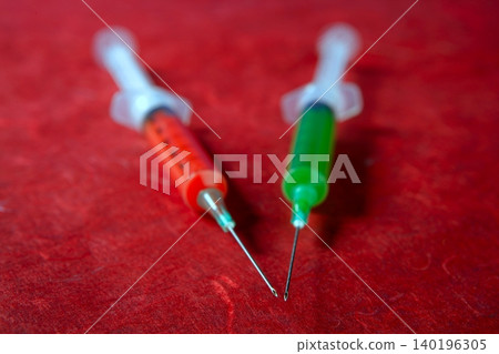 Two red and green syringe, health, addiction, medical research Two red and green syringe, health, addiction, medical research 140196305