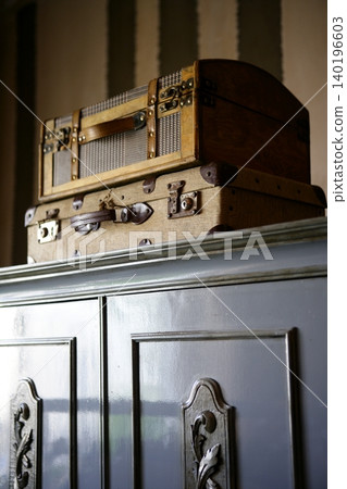 Old suitcases over the wardrobe Old suitcases over the wardrobe 140196603