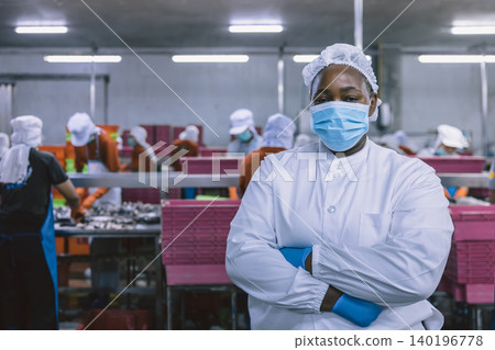 Portrait of African black woman worker in food factory standing confident at with hygiene uniform Portrait of African black woman worker in food factory standing confident at with hygiene uniform 140196778