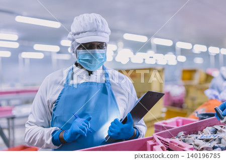 Food factory worker working check the freshness of seafood fish delivered to food processing plant. Food factory worker working check the freshness of seafood fish delivered to food processing plant. 140196785