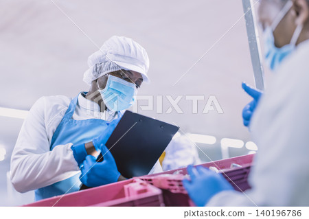Food factory worker working check the freshness of seafood fish delivered to food processing plant. 140196786