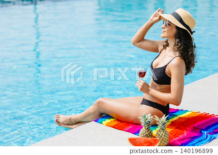 Beauty woman happy relax at swimming pool summer holiday travel vacation. Girl at luxury resort Beauty woman happy relax at swimming pool summer holiday travel vacation. Girl at luxury resort 140196899