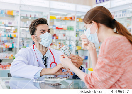 Pharmacy doctor selling medicine to sick women suggest health consult to select right good medicine in drugstore. 140196927