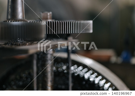 Metal gear spins with industry engineering precision closeup with copy space for text Metal gear spins with industry engineering precision closeup with copy space for text 140196967