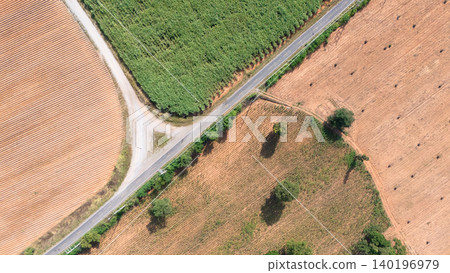 Aerial view of winding road through vibrant farmland Aerial view of winding road through vibrant farmland 140196979