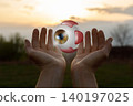 Glowing orb held in the air 140197025
