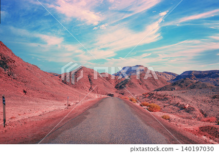 Driving a car on a mountain road in the desert. View of sandstone mountains through the windscreen. Timna Park, Israel Driving a car on a mountain road in the desert. View of sandstone mountains through the windscreen. Timna Park, Israel 140197030