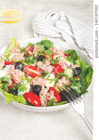 salad with canned tuna, vegetable salad with quail eggs, lettuce and romaine leaves, red onion, cherry tomatoes, olives, keto food, healthy eating, 140197082