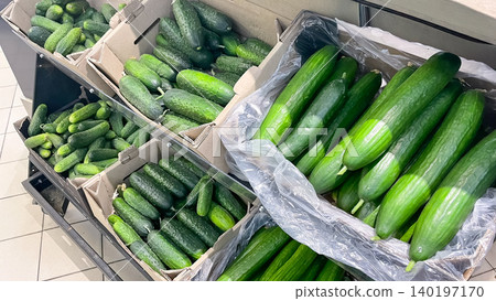 Abundance of fresh organic green cucumbers in crates on a store shelf Abundance of fresh organic green cucumbers in crates on a store shelf 140197170