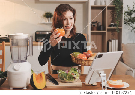 Woman preparing green smoothie in bright kitchen with fresh fruits and vegetables, healthy eating lifestyle moment in natural daylight Woman preparing green smoothie in bright kitchen with fresh fruits and vegetables, healthy eating lifestyle moment in natural daylight 140197254