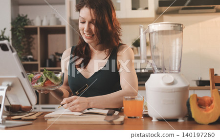 Woman preparing green smoothie in bright kitchen with fresh fruits and vegetables, healthy eating lifestyle moment in natural daylight Woman preparing green smoothie in bright kitchen with fresh fruits and vegetables, healthy eating lifestyle moment in natural daylight 140197260