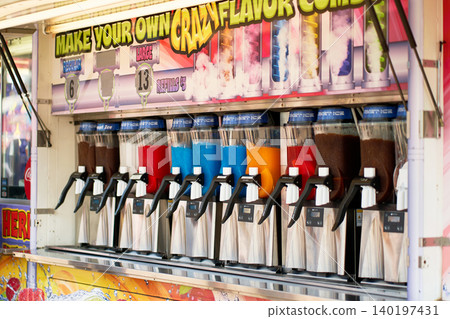 Row of slushie machines with multi-colored frozen drinks at a festival food concession trailer Row of slushie machines with multi-colored frozen drinks at a festival food concession trailer 140197431