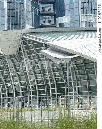 Modern architectural design with curved glass facade and steel structure Modern architectural design with curved glass facade and steel structure 140197456