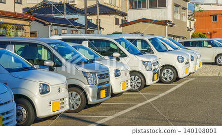 Sakata, Yamagata, Japan - Oct 5 2024, A panoramic view of parked white Kei cars, rental, without people, at daytime, Sakata, Japan Sakata, Yamagata, Japan - Oct 5 2024, A panoramic view of parked white Kei cars, rental, without people, at daytime, Sakata, Japan 140198001