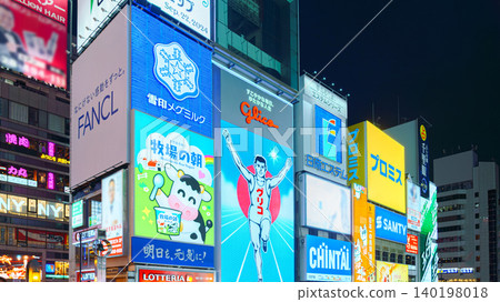 Osaka, Japan - Sep 22 2024, Panoramic view of Dotonbori street with various cafes, restaurants, bright signs and advertisements, illumination, a lot of people walking, at night, Osaka, Japan Osaka, Japan - Sep 22 2024, Panoramic view of Dotonbori street with various cafes, restaurants, bright signs and advertisements, illumination, a lot of people walking, at night, Osaka, Japan 140198018